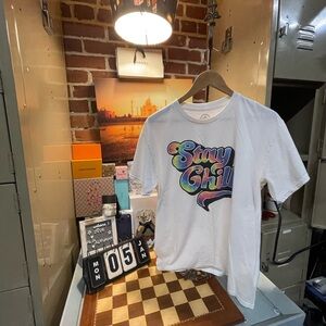 Stay Chill" graphic T-shirt with rainbow tie-dye lettering